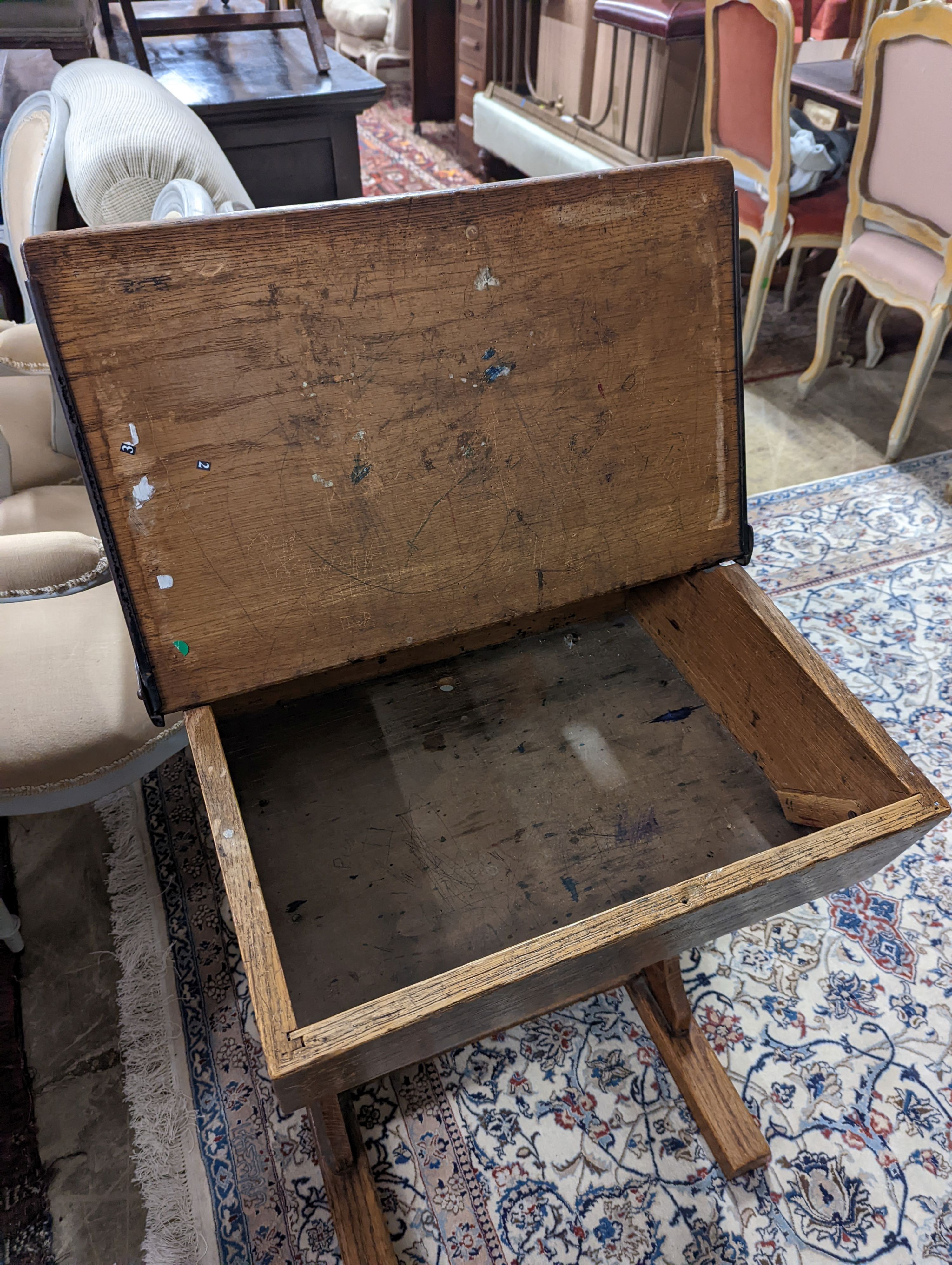 A vintage oak student's desk, width 57cm, depth 46cm, height 71cm with a beech and elm chair